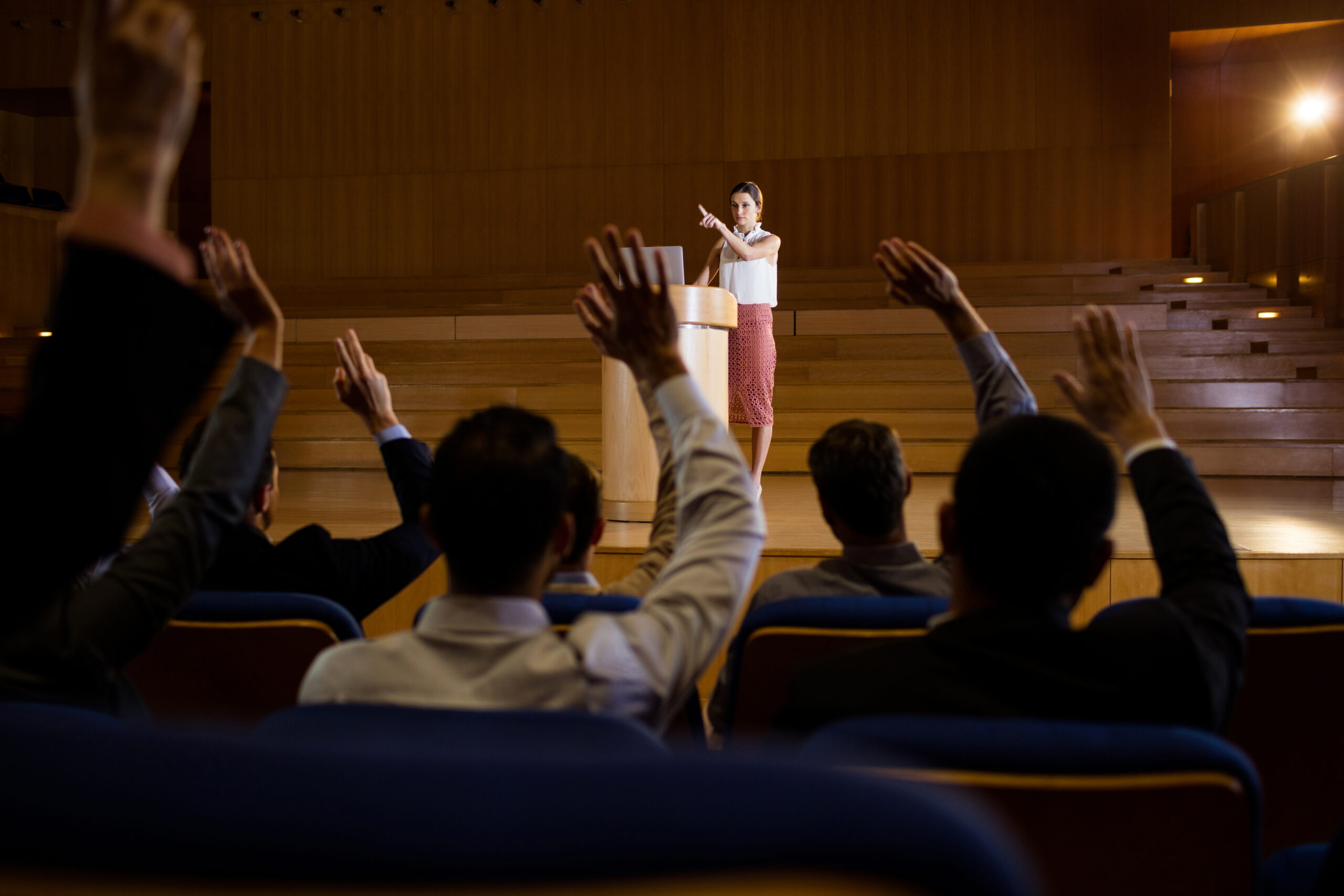 Female business executive giving a speech at conference center